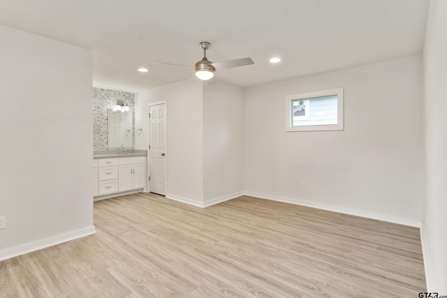 spare room featuring ceiling fan, light hardwood / wood-style flooring, and sink