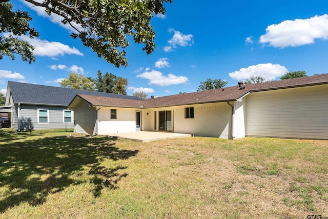 rear view of property with a patio area and a yard