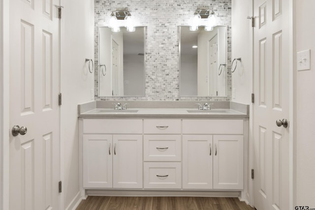 bathroom with vanity, hardwood / wood-style flooring, and backsplash