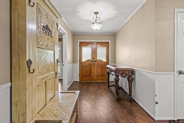 1108 Quitman, Pittsburg, TX 75686 - foyer entrance featuring a wainscoted wall, dark wood-style floors, ornamental molding, a chandelier, and french doors
