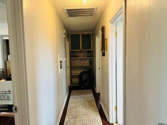 hallway featuring wood walls and dark hardwood / wood-style floors