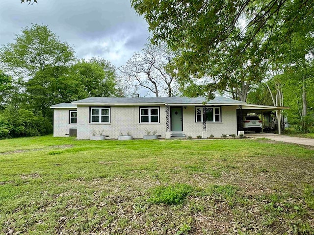 ranch-style home featuring a carport and a front yard