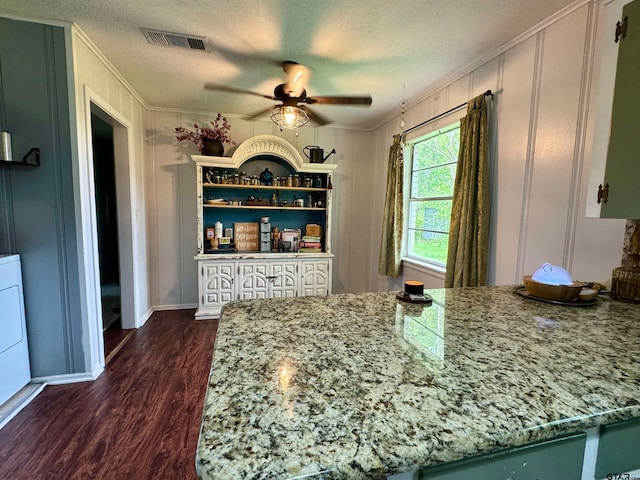 kitchen featuring ceiling fan, light stone countertops, dark hardwood / wood-style floors, and ornamental molding