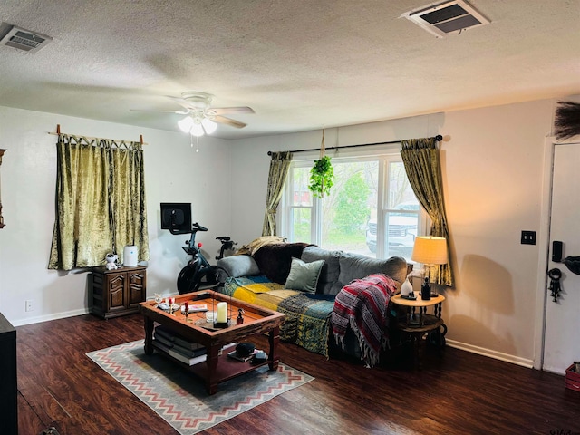 living room featuring a textured ceiling, dark hardwood / wood-style floors, and ceiling fan