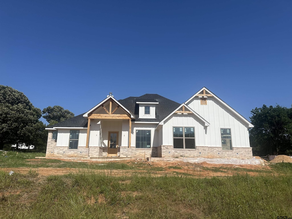 13992 Cedar Vista Ln, Tyler, TX 75704 - modern inspired farmhouse with board and batten siding, a shingled roof, and stone siding