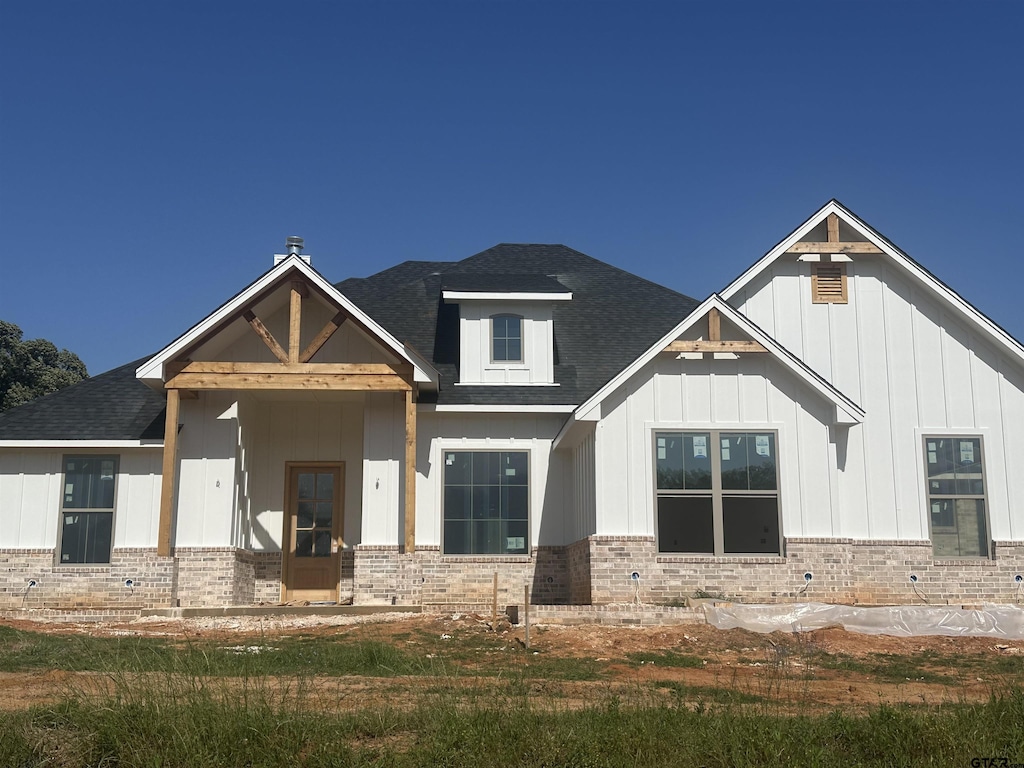 13992 Cedar Vista Ln, Tyler, TX 75704 - view of front of home featuring brick siding, roof with shingles, and board and batten siding
