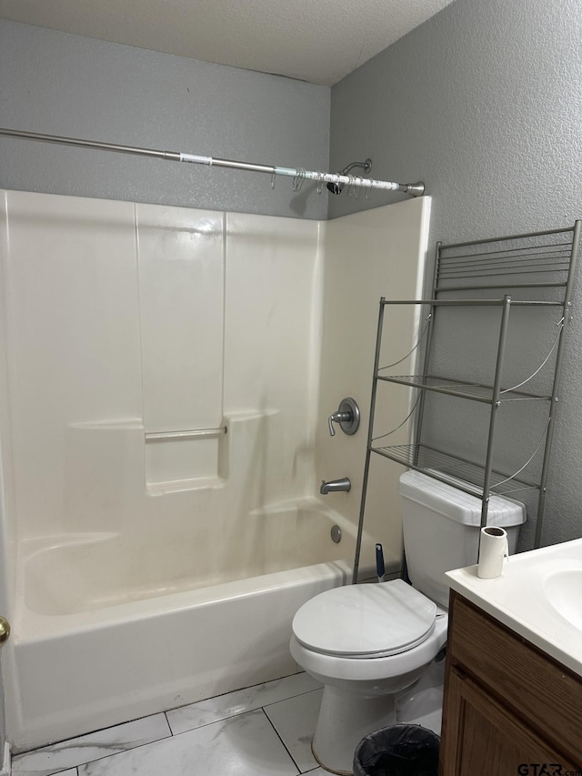 full bathroom featuring vanity, toilet, a textured ceiling, and bathtub / shower combination