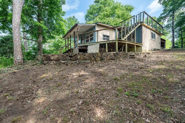 19748 Northside Dr, Winona, TX 75792 - back of property with stairway and a wooden deck
