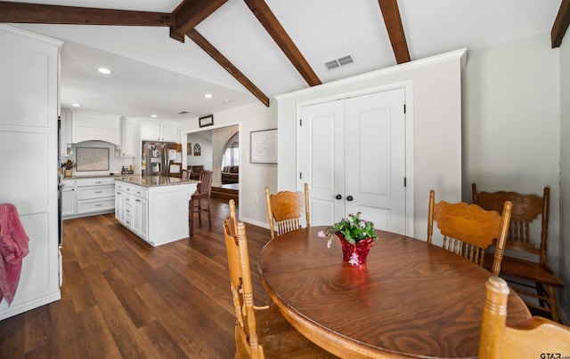 dining space featuring lofted ceiling with beams and dark wood-type flooring