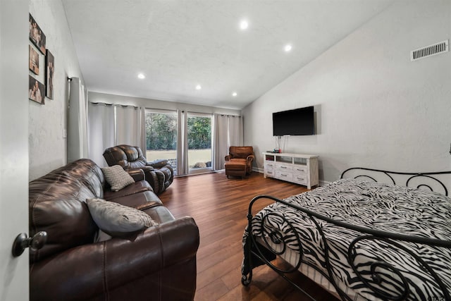 bedroom featuring vaulted ceiling, dark hardwood / wood-style floors, and access to exterior