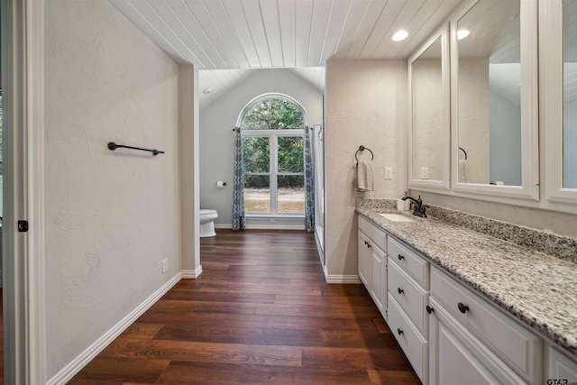 bathroom with vaulted ceiling, wood-type flooring, vanity, toilet, and wooden ceiling