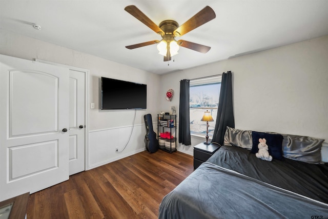 bedroom with dark hardwood / wood-style floors and ceiling fan