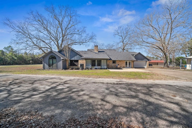 ranch-style home featuring a garage and a front yard