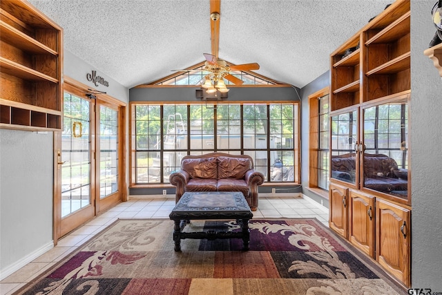 1304 Azalea Dr, Sulphur Springs, TX 75482 - sunroom / solarium featuring french doors, lofted ceiling, a textured ceiling, tile patterned flooring, and plenty of natural light