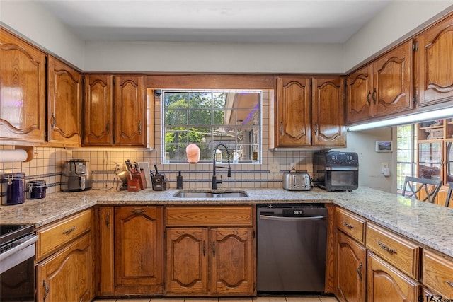 1304 Azalea Dr, Sulphur Springs, TX 75482 - kitchen with appliances with stainless steel finishes, backsplash, and brown cabinets