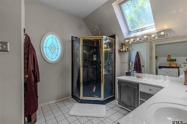 1304 Azalea Dr, Sulphur Springs, TX 75482 - full bath with a skylight, a stall shower, double vanity, vaulted ceiling, and tile patterned floors