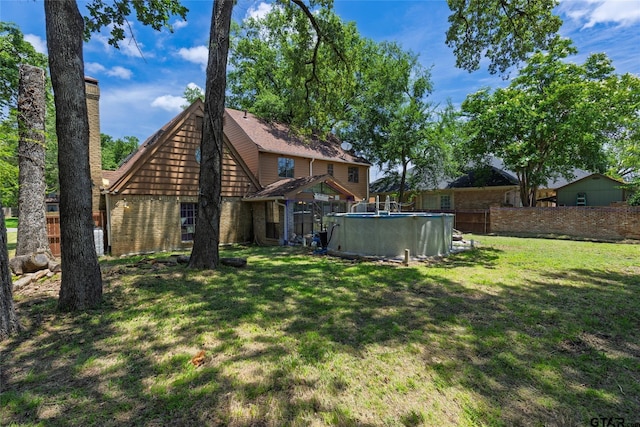 1304 Azalea Dr, Sulphur Springs, TX 75482 - back of property featuring brick siding and an outdoor pool