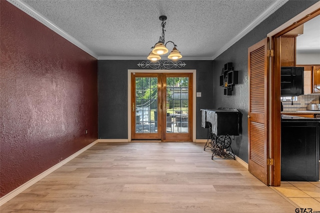 1304 Azalea Dr, Sulphur Springs, TX 75482 - dining area featuring a textured wall, light wood-style floors, a chandelier, a textured ceiling, and ornamental molding