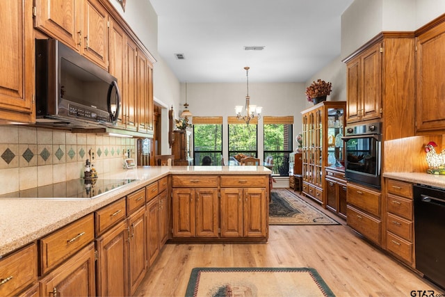 19132 Falls Creek Dr, Flint, TX 75762 - kitchen featuring brown cabinets, visible vents, light wood-type flooring, black appliances, and tasteful backsplash