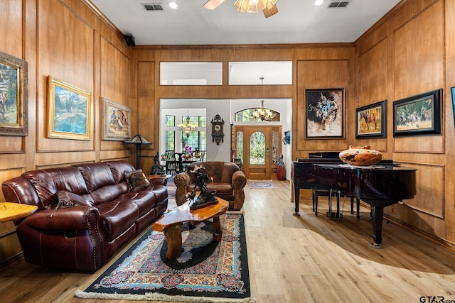 19132 Falls Creek Dr, Flint, TX 75762 - living area featuring light wood-style flooring, visible vents, a ceiling fan, and wood walls