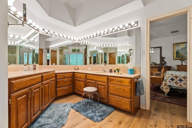 19132 Falls Creek Dr, Flint, TX 75762 - ensuite bathroom featuring double vanity, wood finished floors, visible vents, a sink, and ensuite bath