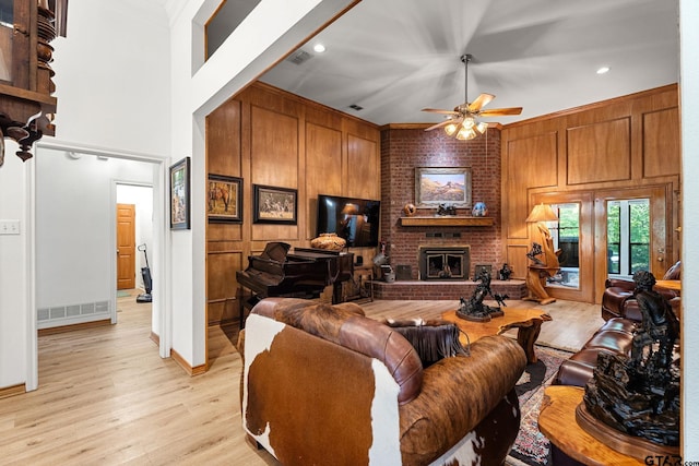 19132 Falls Creek Dr, Flint, TX 75762 - living area with crown molding, light wood-style flooring, ceiling fan, a fireplace, and visible vents
