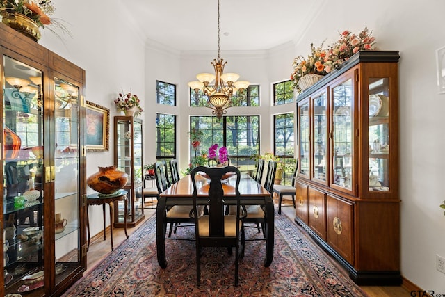 19132 Falls Creek Dr, Flint, TX 75762 - dining room with baseboards, wood finished floors, an inviting chandelier, and ornamental molding