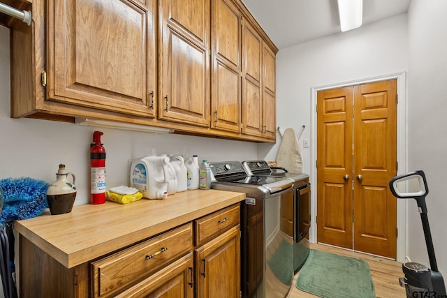 19132 Falls Creek Dr, Flint, TX 75762 - laundry room featuring cabinet space, light wood-style floors, and washer and dryer