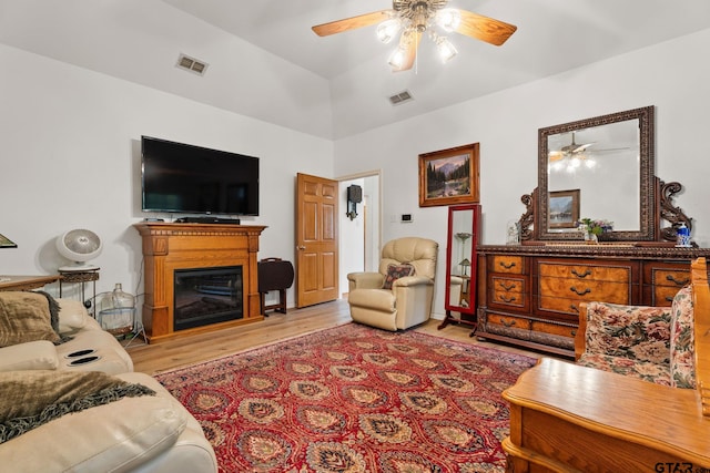 19132 Falls Creek Dr, Flint, TX 75762 - living room featuring a glass covered fireplace, light wood-type flooring, visible vents, and ceiling fan