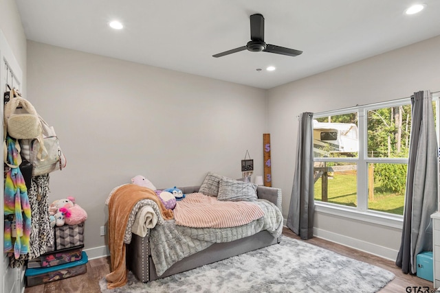 bedroom with hardwood / wood-style floors and ceiling fan