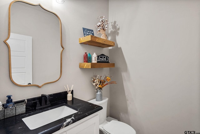 bathroom featuring toilet and vanity