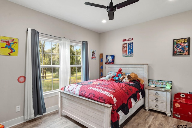 bedroom with hardwood / wood-style floors and ceiling fan