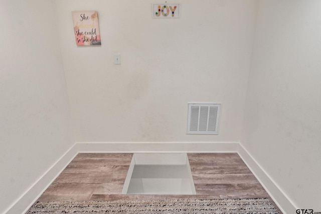 laundry area with hardwood / wood-style floors