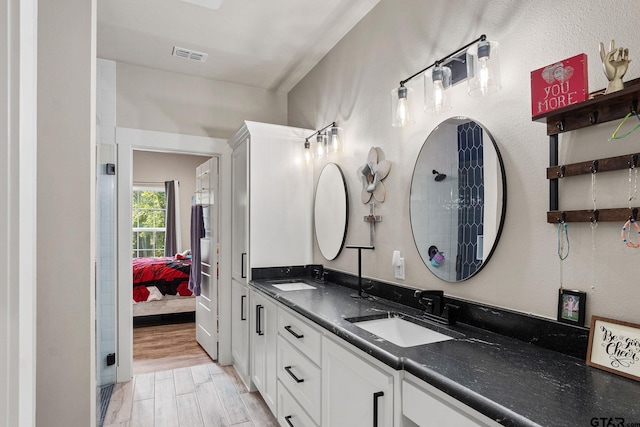 bathroom with vanity and wood-type flooring