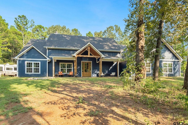 view of front of home with a front lawn and french doors