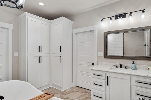 bathroom with a washtub and vanity