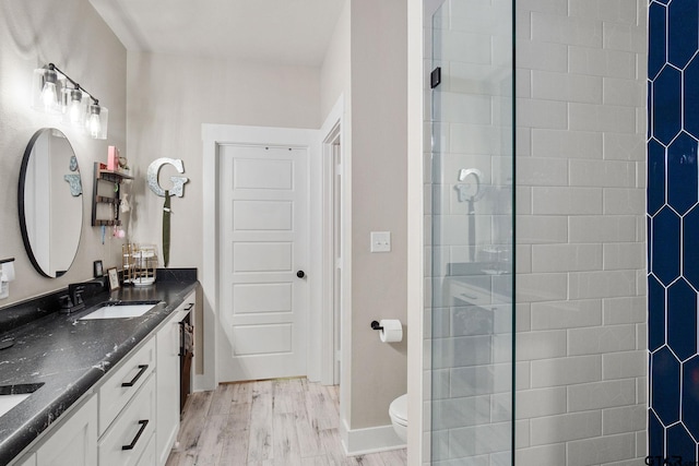 bathroom with hardwood / wood-style floors, vanity, and toilet