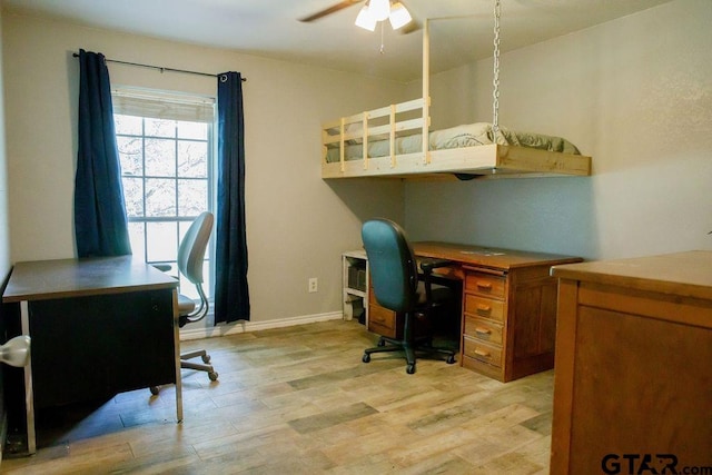 office with light wood finished floors, ceiling fan, and baseboards