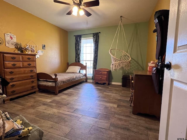 bedroom with wood finished floors and a ceiling fan