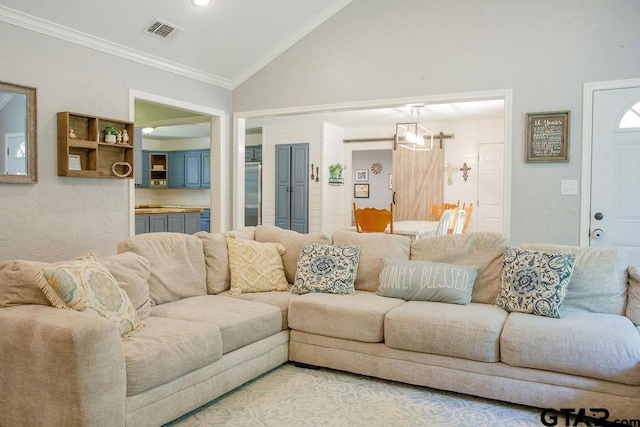 living room with crown molding, a chandelier, visible vents, and vaulted ceiling