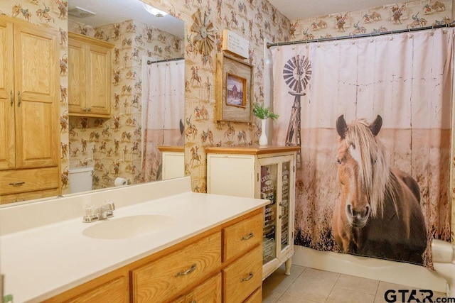 full bath featuring tile patterned flooring, vanity, toilet, and wallpapered walls