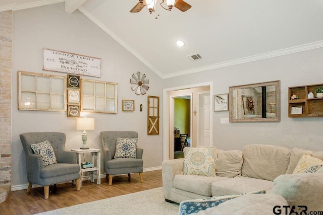 living room featuring baseboards, ceiling fan, wood finished floors, vaulted ceiling with beams, and crown molding