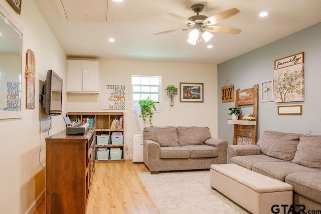 living area featuring attic access, recessed lighting, light wood-style floors, and a ceiling fan