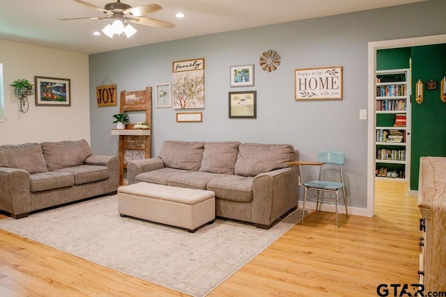 living area featuring ceiling fan, baseboards, wood finished floors, and recessed lighting