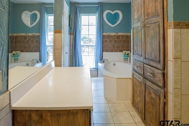 bathroom featuring a garden tub, tile walls, and tile patterned floors