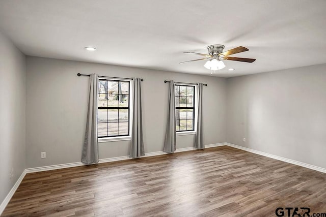 empty room with recessed lighting, baseboards, wood finished floors, and ceiling fan