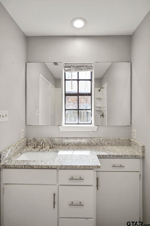 full bathroom with a shower and vanity