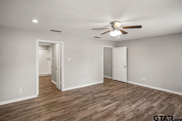 unfurnished bedroom featuring visible vents, baseboards, and wood finished floors