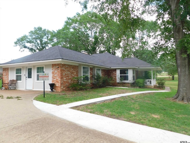 ranch-style house with brick siding and a front lawn