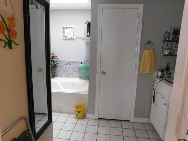 bathroom with tile patterned floors and a bath